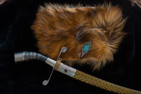 An ancient saber. A chic version of a combat weapon lying on a fur cape next  Stock Photos