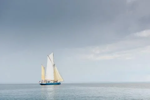 Ancient sail ship, magic reflections on water surface, sailing regatta in the Stock Photos