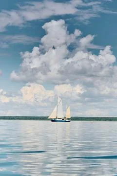 Ancient sail ship, magic reflections on water surface, sailing regatta in the Stock Photos