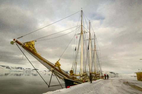 An ancient sailing ship by the dock Stock Photos