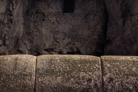Ancient script engraved on the walls of the Butrint temple in Albania. But... Stock Photos