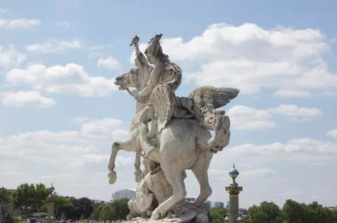 Ancient sculpture in paris over the blue sky Stock Photos