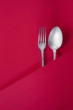 Ancient silver fork and spoon on red background Stock-Fotos