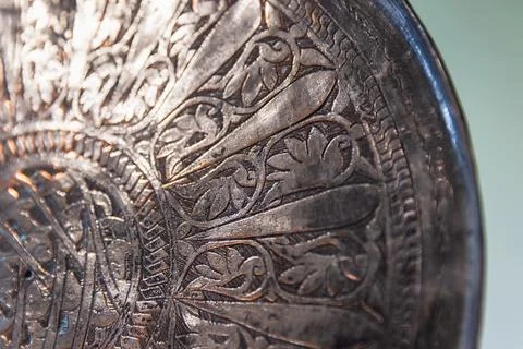 An ancient silver plate with embossed patterns is in antique shop Stock Photos
