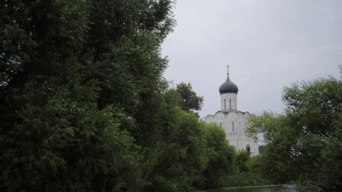 An ancient small temple stands on the shore of a reservoir during the rain Stock Footage 167405415