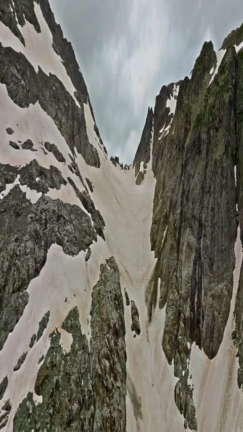 Ancient snow glacier among high mountains. The peaks of the mountains are 库存影片 311489145