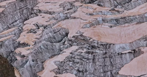 Ancient snow glacier among high mountains. The peaks of the mountains are 스톡 동영상 311489909