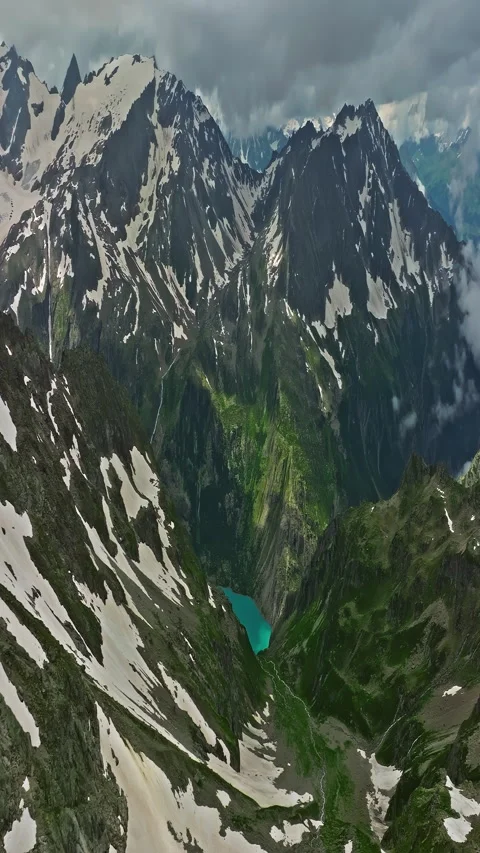 Ancient snow glacier among high mountains. The peaks of the mountains are 스톡 동영상 311645974