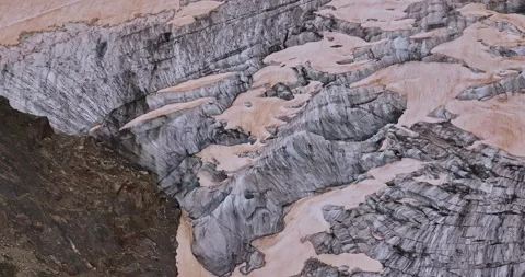 Ancient snow glacier among high mountains. The peaks of the mountains are Video stock 311646308