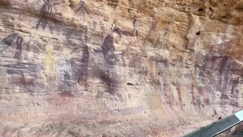 Ancient Split Rock Art site on Sandstone Cliff Surrounded by Forest Stock Footage 346434183