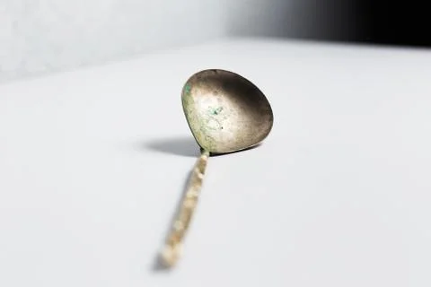 Ancient spoon on white background. Stock Photos