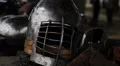 Ancient steel helmet and leather outfit of medieval knight at history museum HD Footage