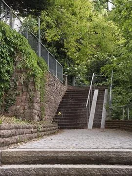 Ancient Steps Ascent. Weathered Steps Leading Up Shaded Cobblestone Incline Stock Photos