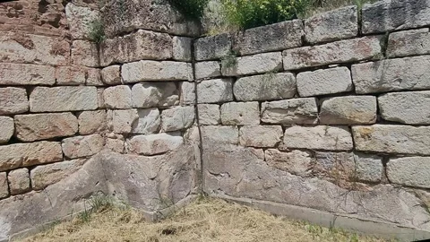 Ancient Stone Arch and Ruined Walls in Green Grass Field Stock Footage 336635568