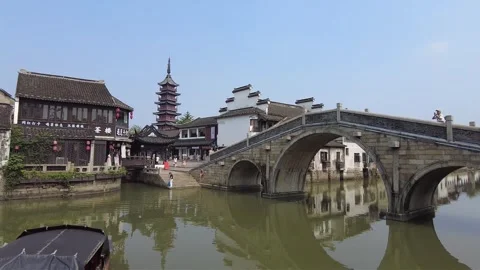 Ancient stone arch bridge over canal in an water town of China Stock Footage 337887998