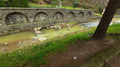 Ancient stone arches span a slow-flowing river. Vucjanka Canyon, Serbia Vidéo 332147541