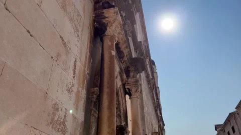 Ancient stone architecture bathed in bright sunlight and clear blue sky Stock Footage 345259881