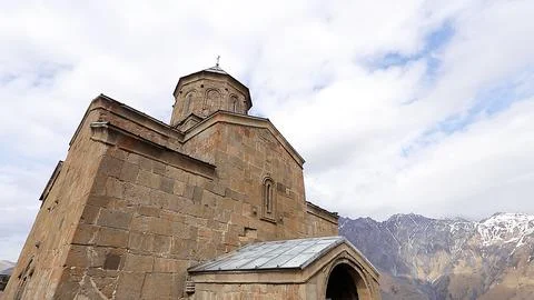 Ancient stone architecture of Gergeti Trinity Church in Georgia Stock Photos