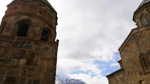 Ancient stone architecture of Gergeti Trinity Church in Georgia Stock Photos