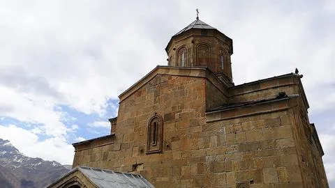 Ancient stone architecture of Gergeti Trinity Church in Georgia Stock Photos