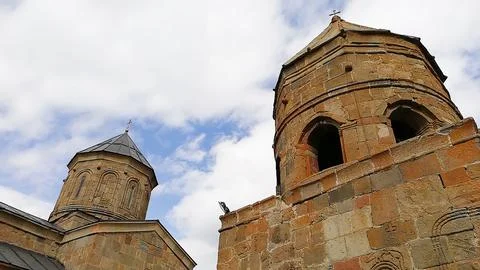 Ancient stone architecture of Gergeti Trinity Church in Georgia Stock Photos