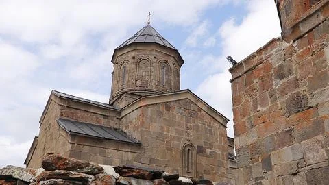 Ancient stone architecture of Gergeti Trinity Church in Georgia Stock Photos