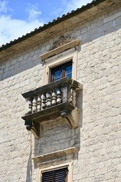 Ancient Stone Balcony with Balusters and Relief Carvings in Old Town Kotor,.. Stock Photos