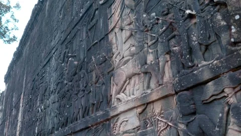 Ancient stone bas-relief depicting people, gods and horses on the wall in Angkor Stock Footage 318690253