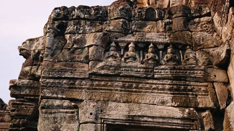 Ancient stone bas reliefs and sculptures depicting religious figures on the wall Video stock 325071823