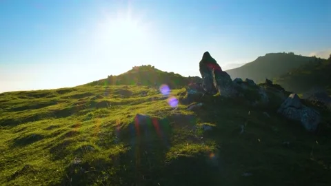 Ancient Stone with Beautiful background view of Hills Meadow and Sun Flares. Stock Footage 144173995