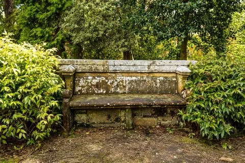 Ancient stone bench in the park Stock Photos