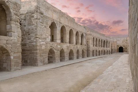 Ancient stone brick wall with embedded recessed arches at the Citadel of Qaitbay Stock Photos