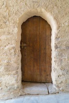 Ancient stone bricks wall and old wooden door Stock Photos