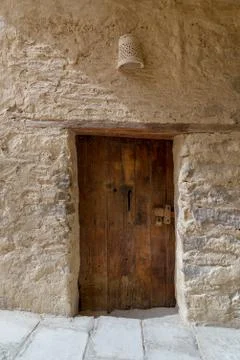 Ancient stone bricks wall and old wooden door Stock Photos