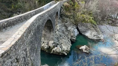 The ancient stone bridge over a clear river Stock Footage 297513022
