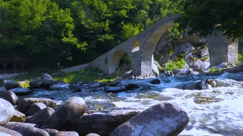 Ancient stone bridge over mountain river 스톡 동영상 135962469