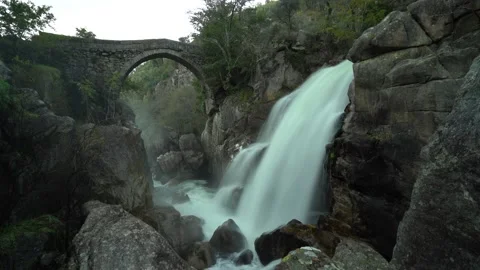 Ancient stone bridge with waterfall. Misarela. 4K long expo Stock Footage 165176137
