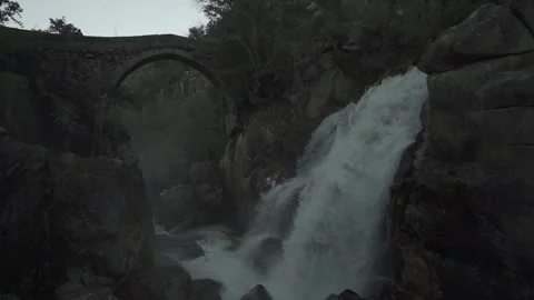 Ancient stone bridge with waterfall. Misarela. 100fps Stock Footage 165176139