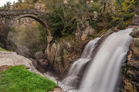 Ancient stone bridge with waterfall 写真素材