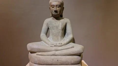 Ancient stone Buddha statue meditating on a coiled serpent base, Cambodia Stock Footage 335420059