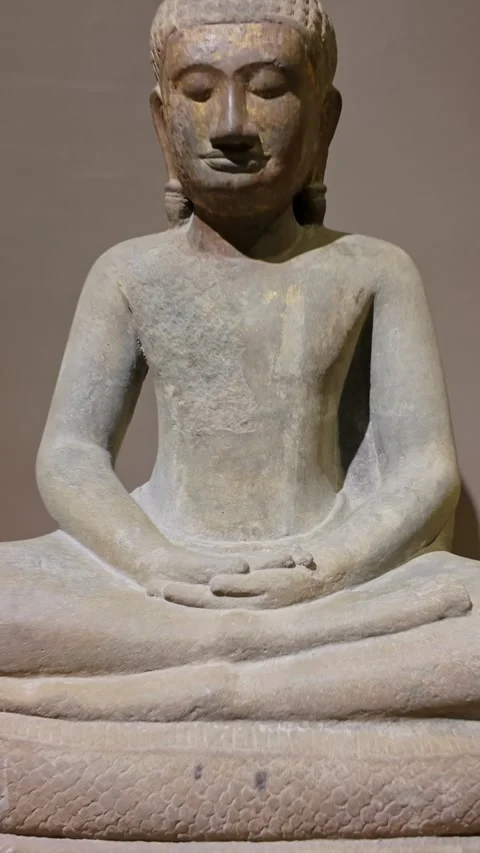 Ancient stone Buddha statue meditating on a coiled serpent base, Cambodia Stock Footage 335421616
