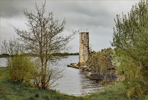 An ancient stone built lighthouse Stock Photos