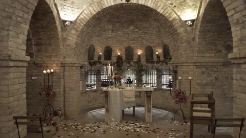 Ancient stone chapel features charming altar with candlelit ambiance 動画素材 291690173