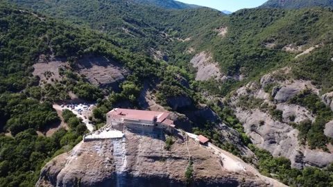 Ancient Stone Christian Monastery Surrounded by Mountains and Cliffs in Greece Video stock 318610266
