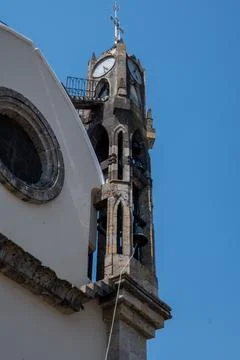 Ancient stone clock tower with bells against bright blue sky in Guadalajara Stock Photos
