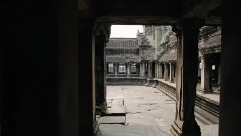 Ancient stone columns and corridors of the angkor wat temple complex in cambodia Stock Footage 325370666