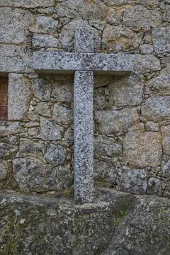 Ancient stone cross on medieval wall Stock Photos