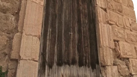 Ancient stone doorway with upward camera movement toward sky Stock Footage 313295547