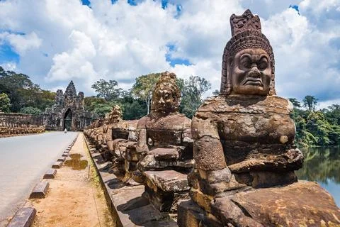 Ancient stone guardian statues lining the causeway at the South Gate of Angko Stock Photos