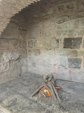 Ancient Stone Hearth with Campfire Inside Stock Photos